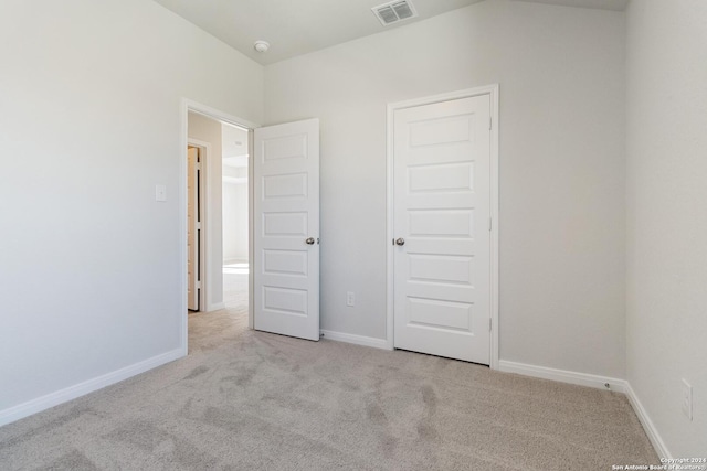 unfurnished bedroom featuring light colored carpet