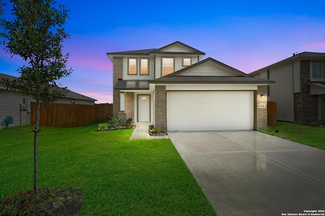 view of front of house featuring a garage and a lawn