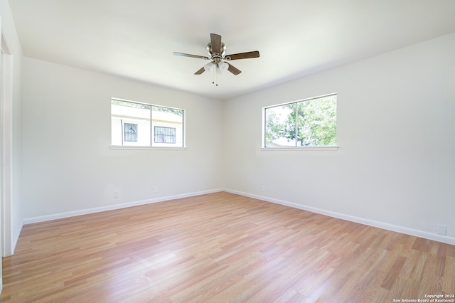 unfurnished room with ceiling fan and light wood-type flooring