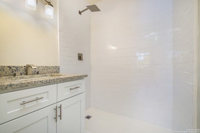 bathroom featuring vanity and a tile shower