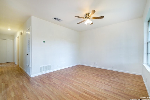 empty room with light hardwood / wood-style flooring and ceiling fan