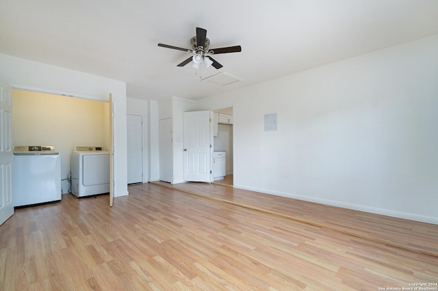 interior space featuring separate washer and dryer, ceiling fan, and light hardwood / wood-style flooring