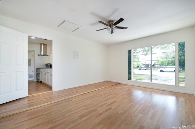 unfurnished room featuring ceiling fan and light wood-type flooring