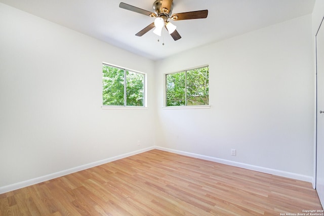 empty room featuring ceiling fan and light hardwood / wood-style flooring