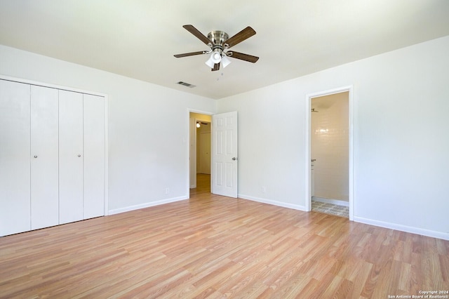 unfurnished bedroom featuring ceiling fan, light hardwood / wood-style floors, and a closet