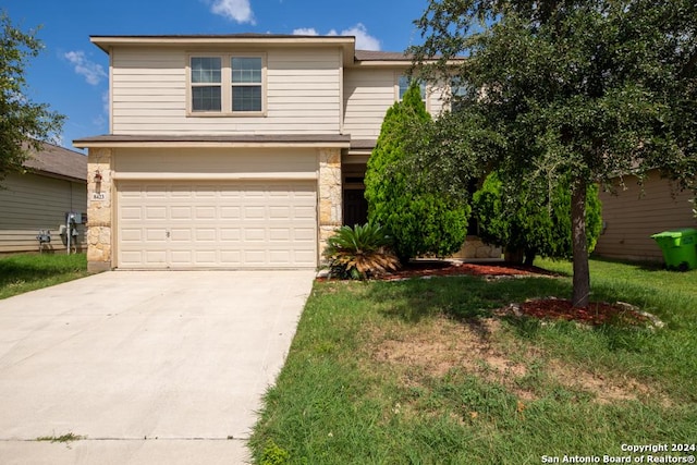 view of front property with a garage and a front lawn