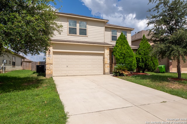 view of front property featuring a garage and a front yard