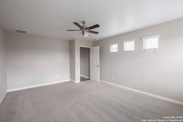 carpeted empty room with ceiling fan