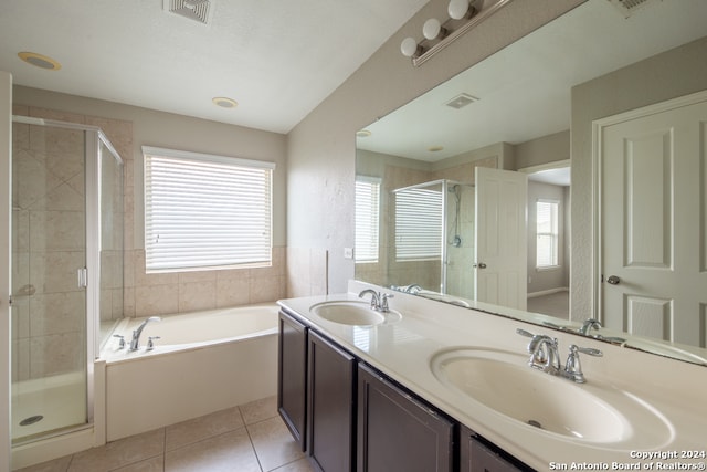 bathroom with shower with separate bathtub, double sink vanity, and tile patterned flooring