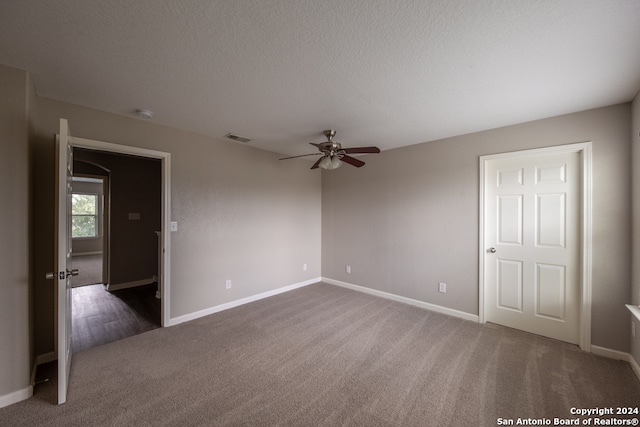 spare room with carpet floors and ceiling fan