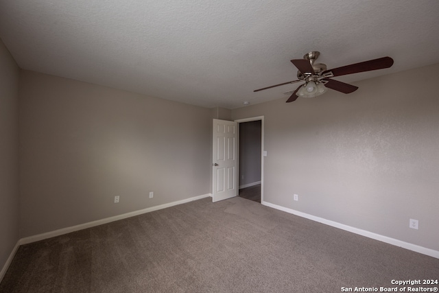 carpeted spare room with a textured ceiling and ceiling fan