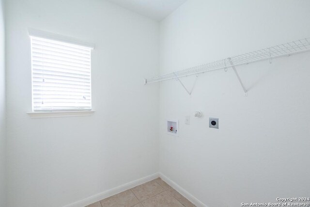 laundry area with light tile patterned floors, electric dryer hookup, and hookup for a washing machine