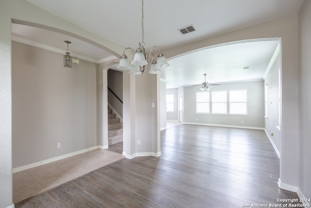 unfurnished room with ceiling fan with notable chandelier and hardwood / wood-style flooring