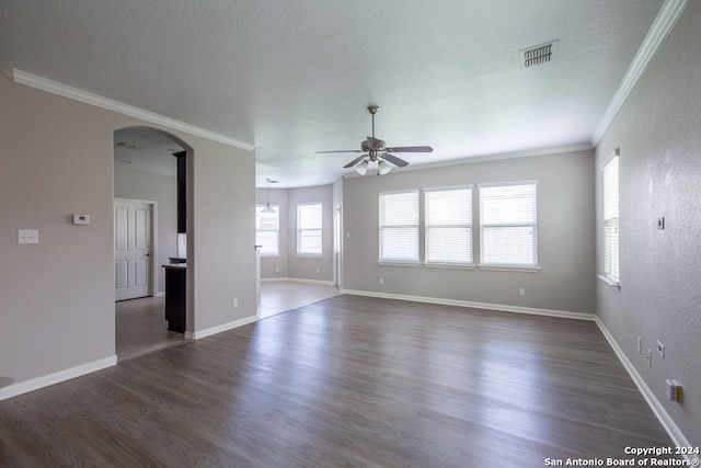 spare room with ceiling fan, crown molding, a textured ceiling, and dark hardwood / wood-style flooring