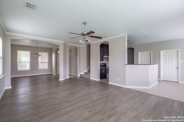 unfurnished living room featuring crown molding, ceiling fan with notable chandelier, and light hardwood / wood-style flooring