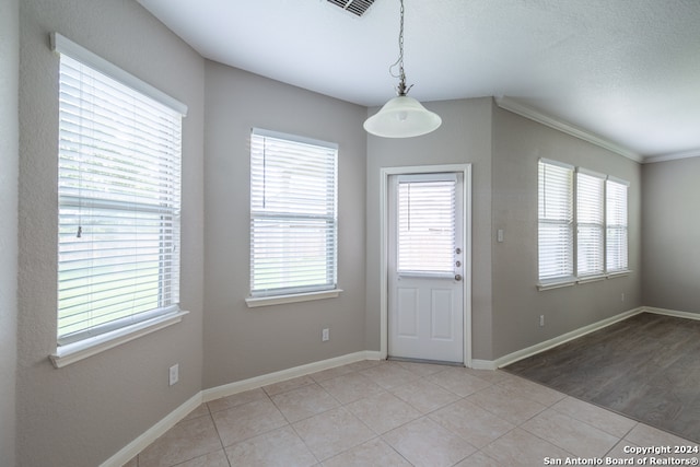 interior space featuring plenty of natural light and light tile patterned floors