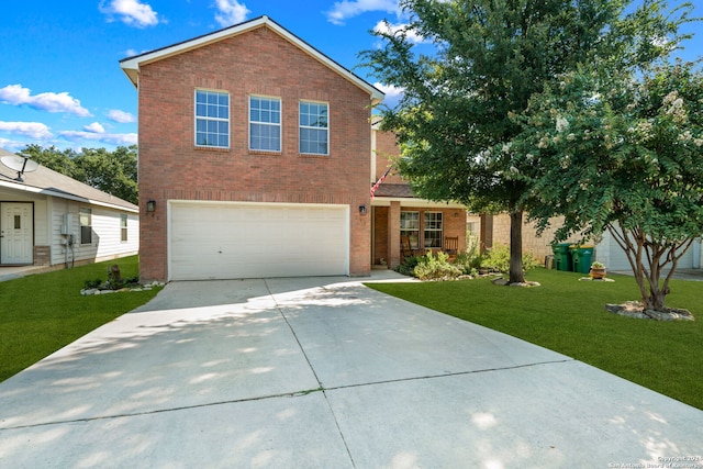 view of property featuring a garage and a front lawn