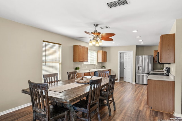 dining room featuring ceiling fan, dark hardwood / wood-style flooring, and plenty of natural light