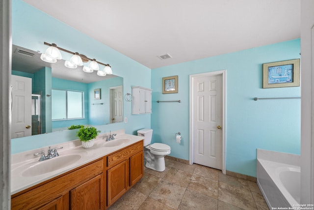 bathroom with double vanity, tile patterned flooring, a tub to relax in, and toilet