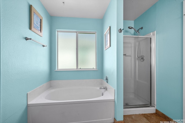 bathroom with tile patterned flooring and plus walk in shower