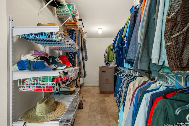 walk in closet with light tile patterned floors