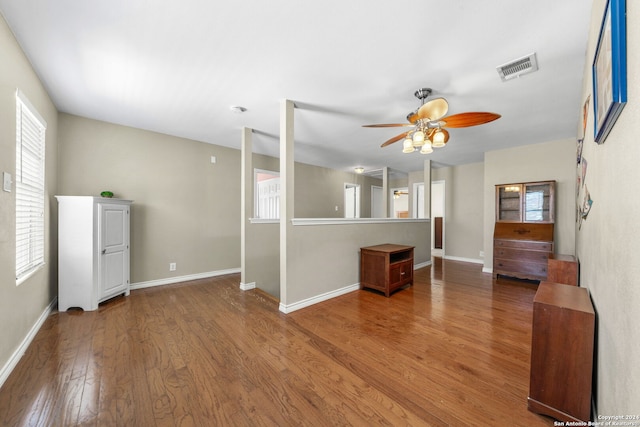 unfurnished living room featuring ceiling fan, hardwood / wood-style flooring, and a wealth of natural light