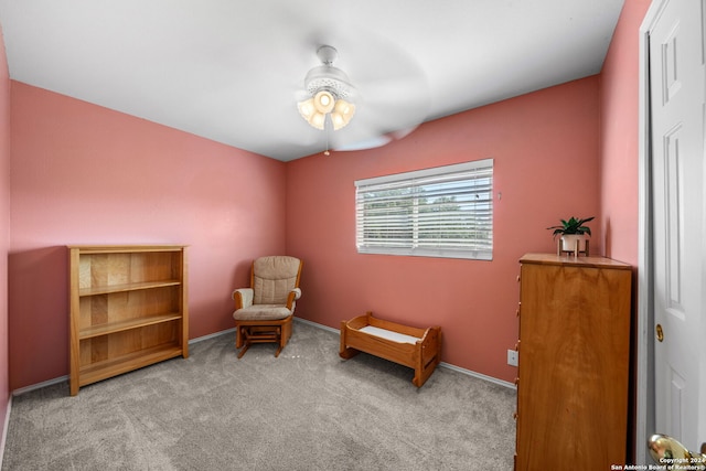 sitting room featuring light carpet and ceiling fan