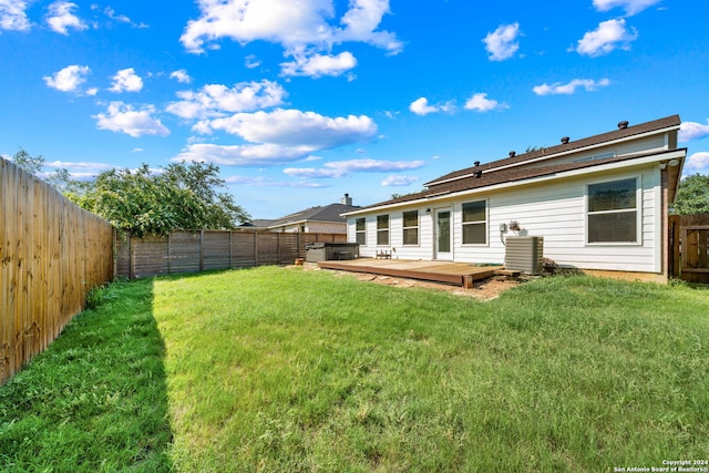 back of house with a yard and a deck