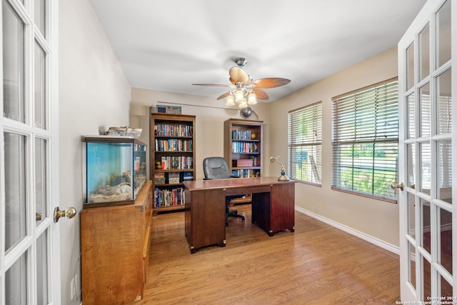 office featuring french doors, ceiling fan, and wood-type flooring