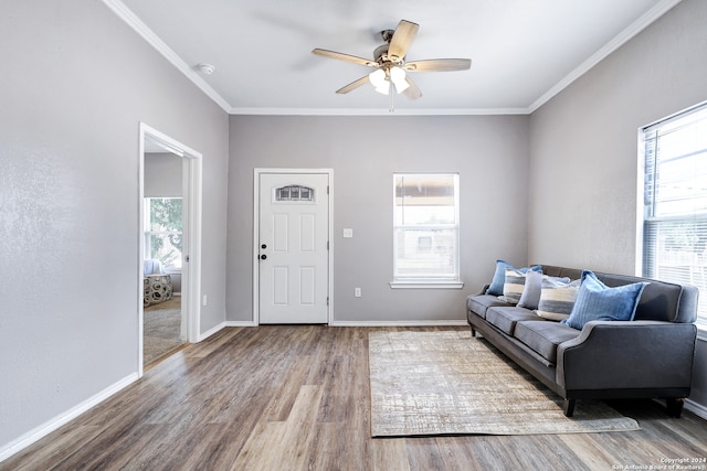 interior space featuring ceiling fan, wood-type flooring, and ornamental molding