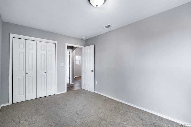 unfurnished bedroom featuring a closet and carpet flooring