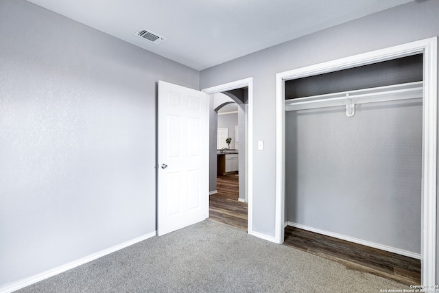 unfurnished bedroom with a closet and wood-type flooring