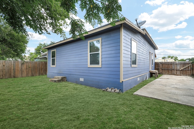 view of home's exterior featuring a yard and a patio