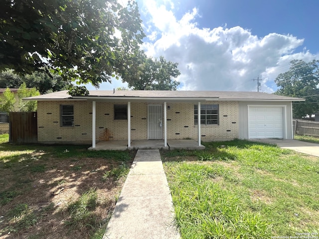 view of front of house with a garage and a front lawn