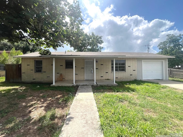 ranch-style home with concrete driveway, crawl space, an attached garage, a front lawn, and brick siding