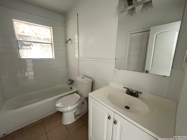 full bathroom featuring tiled shower / bath combo, vanity, tile patterned floors, and toilet