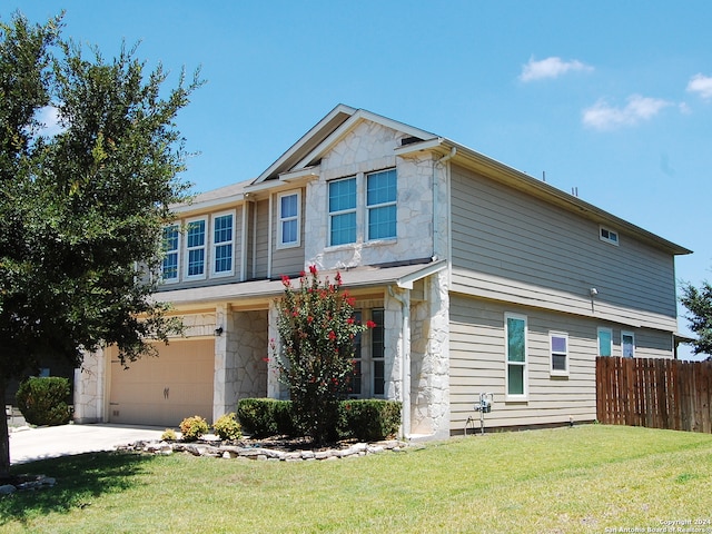 view of front of house featuring a garage and a front lawn