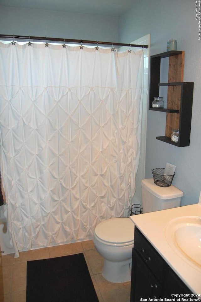 full bathroom with shower / bath combo with shower curtain, tile patterned flooring, vanity, and toilet