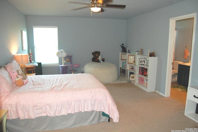 carpeted bedroom featuring ceiling fan and ensuite bathroom