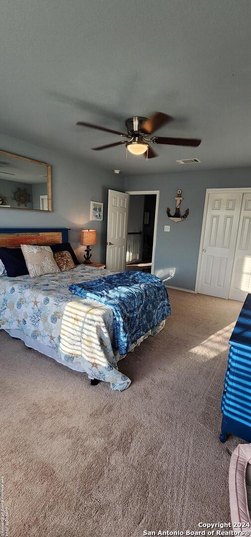 carpeted bedroom with ceiling fan