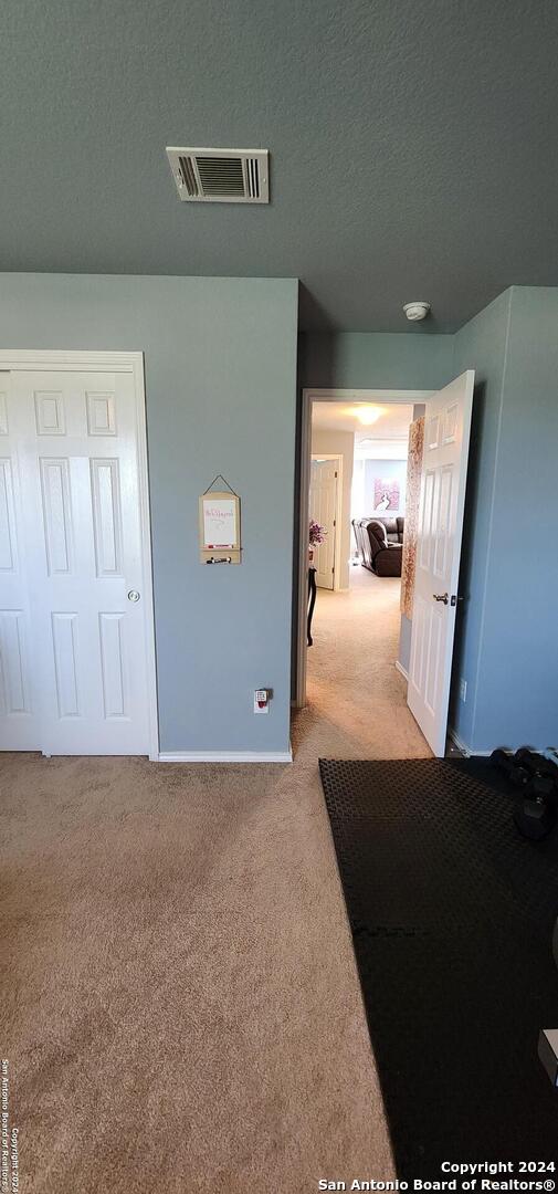 carpeted bedroom with a textured ceiling