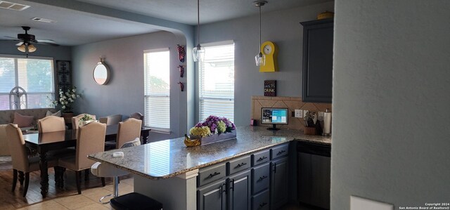 dining room with ceiling fan and sink