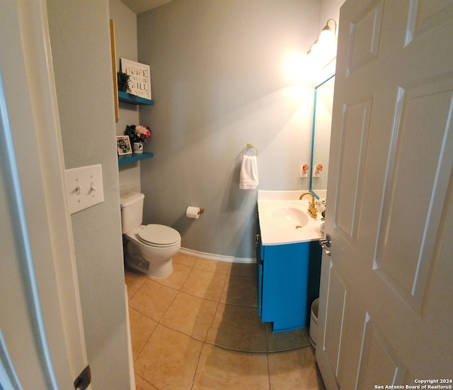 bathroom featuring tile patterned flooring, vanity, and toilet