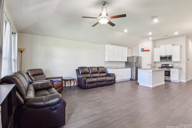 living room with lofted ceiling, wood-type flooring, sink, and ceiling fan