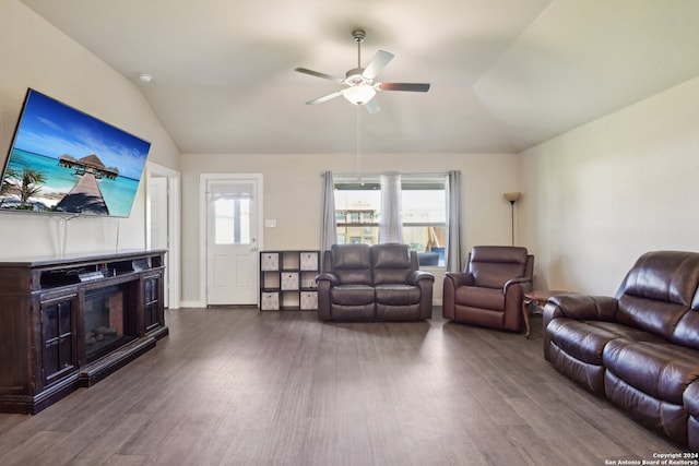 living room featuring ceiling fan, dark hardwood / wood-style flooring, and vaulted ceiling