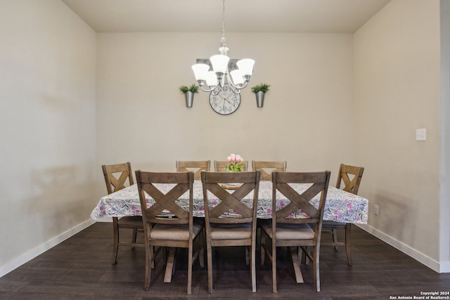 dining room with an inviting chandelier and dark wood-type flooring