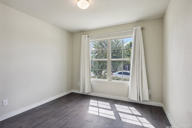 unfurnished room featuring hardwood / wood-style flooring