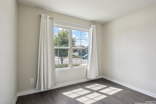 empty room with dark wood-type flooring