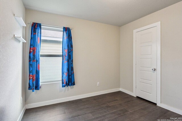 empty room featuring dark hardwood / wood-style floors