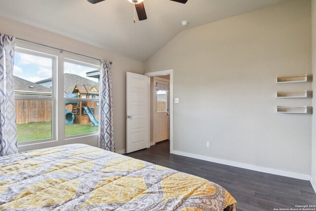 bedroom featuring dark hardwood / wood-style floors, lofted ceiling, multiple windows, and ceiling fan